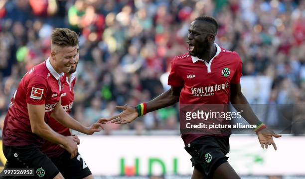 Hannover's Salif Sane celebrating with Waldemar Anton and Kenan Karaman the 1:1 equaliser against Eintracht Frankfurt during the German Bundesliga...
