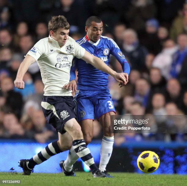 Ashley Cole of Chelsea battles with Seamus Coleman of Everton during the Barclays Premier League match at Stamford Bridge on December 4, 2010 in...