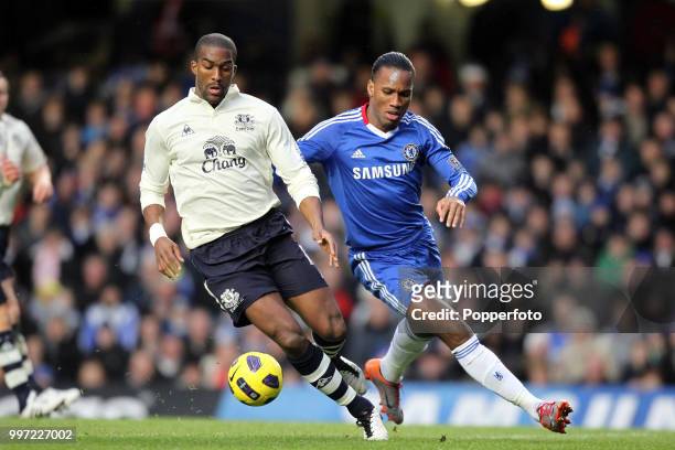 Didier Drogba of Chelsea battles with Sylvain Distin of Everton during the Barclays Premier League match at Stamford Bridge on December 4, 2010 in...