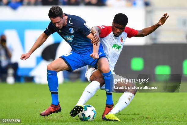 Dpatop - Hoffenheim's Mark Uth vies for the ball with Augsburg's Kevin Danso during the German Bundesliga soccer match between 1899 Hoffenheim and FC...