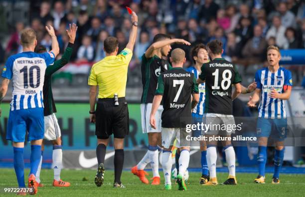 Referee Benjamin Brand shows Hertha's Genki Haraguchi the red card during the German Bundesliga soccer match between Hertha BSC and FC Schalke 04 in...