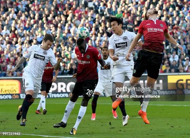 Hannover's Salif Sane and Martin Harnik vying for the ball against Frankfurt's Marco Russ and Makoto Hasebe during the German Bundesliga soccer match...