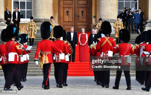 President Donald Trump, from left, Theresa May, U.K. Prime minister, and her husband Philip May watch a live military performance by the bands of the...