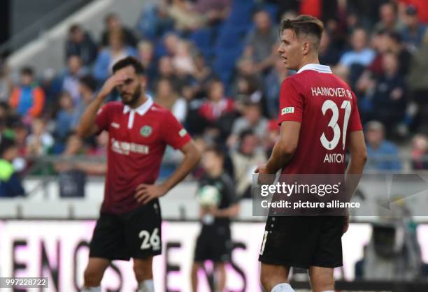 Hanover's Kenan Karaman and Waldemar Anton standing on the field after the German Bundesliga soccer match between Hannover 96 and Eintracht Frankfurt...