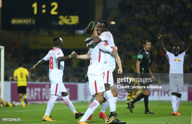 Leipzig's Yussuf Poulsen and Bruma celebrate scoring during the German Bundesliga soccer match between Borussia Dortmund and RB Leipzig at the...