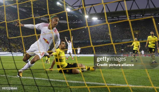 Leipzig's Yussuf Poulsen celebrating the 1:2 while Dortmund's Sokratis lies defeated on the pitch during the German Bundesliga soccer match between...