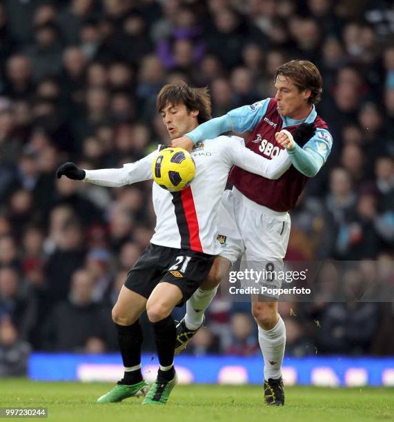 David Silva of Manchester City is challenged by Scott Parker of West Ham United during a Barclays Premier League match at Upton Park on December 11,...