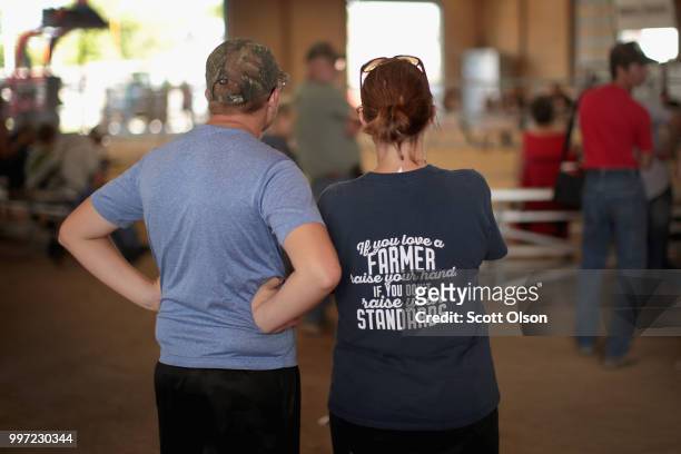 People watch livestock judging at the Iowa County Fair on July 12, 2018 in Marengo, Iowa. The fair, like many in counties throughout the Midwest,...