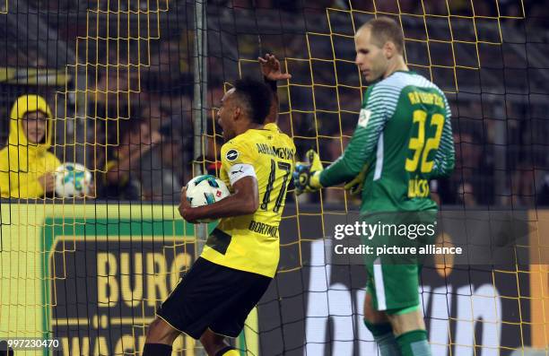 Dortmund's Pierre-Emerick Aubameyang celebrates scoring the 2:3 while Leipzig goalkeeper Peter Gulacsi stands next to him during the German...