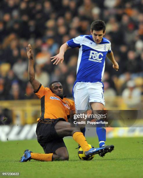 Sylvan Ebanks-Blake of Wolverhampton Wanderers tackles Scott Dann of Birmingham City during a Barclays Premier League match at Molineux on December...