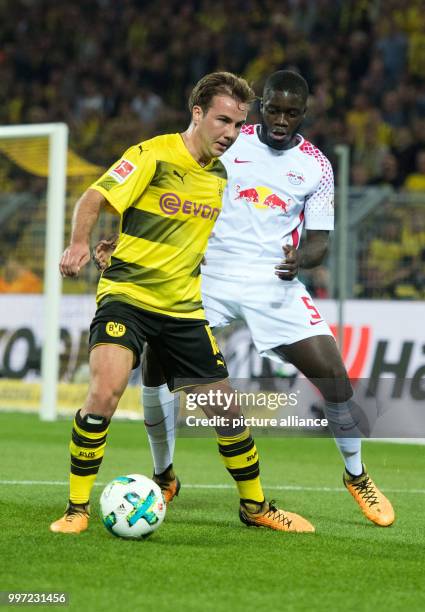 Dortmund's Mario Goetze and Leipzig's Dayot Upamecano vie for the ball during the German Bundesliga soccer match between Borussia Dortmund and RB...