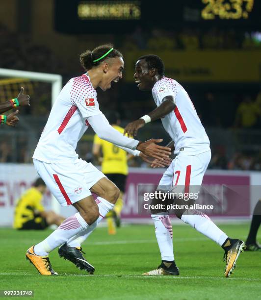 Dpatop - Leipzig's Yussuf Poulsen and Bruma celebrating the 3:2 victory over Dortmund after the German Bundesliga soccer match between Borussia...