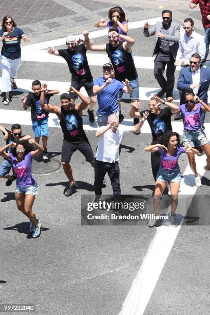 Councilman Mitch O'Farrell dances with the cast of "On Your Feet" during the dedication ceremony of the scramble crosswalk on Hollywood and Vine on...