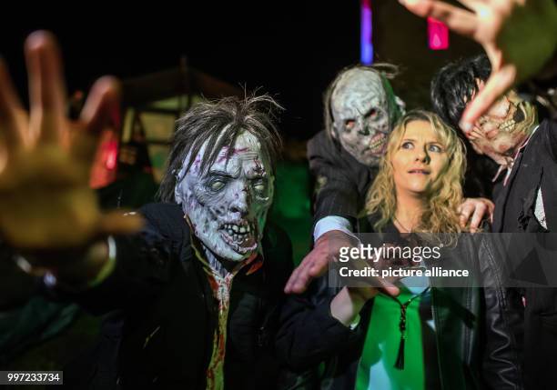 Several "zombies" attempt to grab humans at the rehearsal for Halloween in Pfungstadt, Germany, 14 October 2017. The annual Halloween event has been...