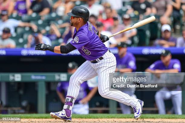 Gerardo Parra of the Colorado Rockies hits a game tying pinch hit RBI single against the Arizona Diamondbacks in the sixth inning of a game at Coors...