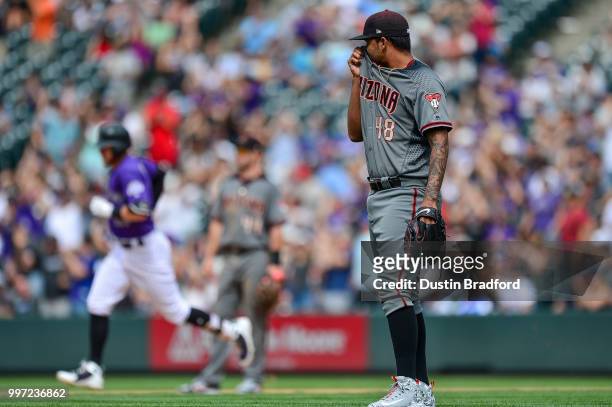 Randall Delgado of the Arizona Diamondbacks reacts after allowing a seventh inning solo homerun to Trevor Story of the Colorado Rockies during a game...