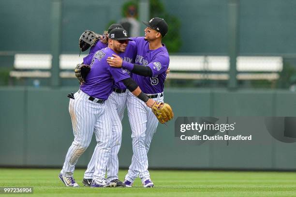 Colorado Rockies outfielders, Gerardo Parra, Charlie Blackmon, and Carlos Gonzalez celebrate a 5-1 win over the Arizona Diamondbacks after a game at...