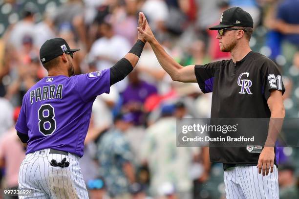 Gerardo Parra and Kyle Freeland of the Colorado Rockies celebrate after a 5-1 win over the Arizona Diamondbacks at Coors Field on July 12, 2018 in...