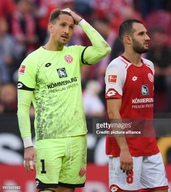 Mainz's goalkeeper René Adler standing beside Levin Oeztunali after the German Bundesliga soccer match between 1. FSV Mainz 05 and Hamburger SV in...
