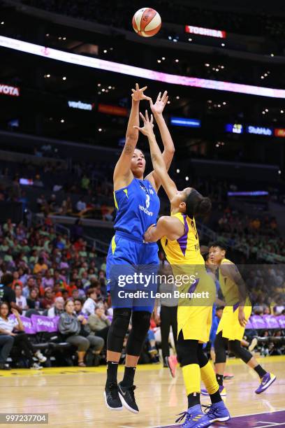 Elizabeth Cambage of the Dallas Wings handles the ball against Candace Parker of the Los Angeles Sparks during a WNBA basketball game at Staples...