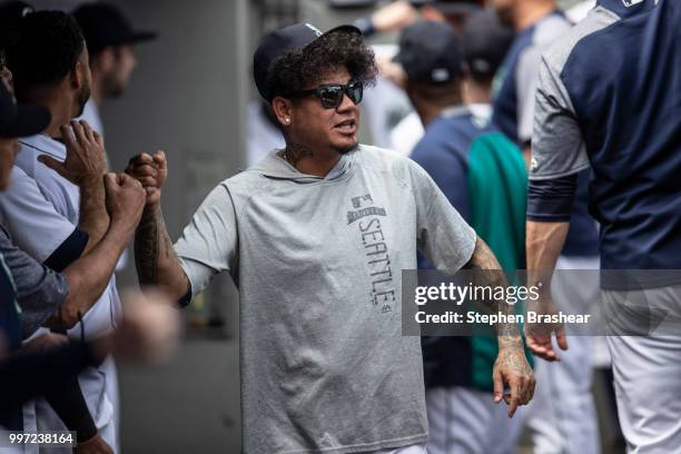 Felix Hernandez of the Seattle Mariners greets teammates in the dugout before a game against the Colorado Rockies at Safeco Field on July 7, 2018 in...