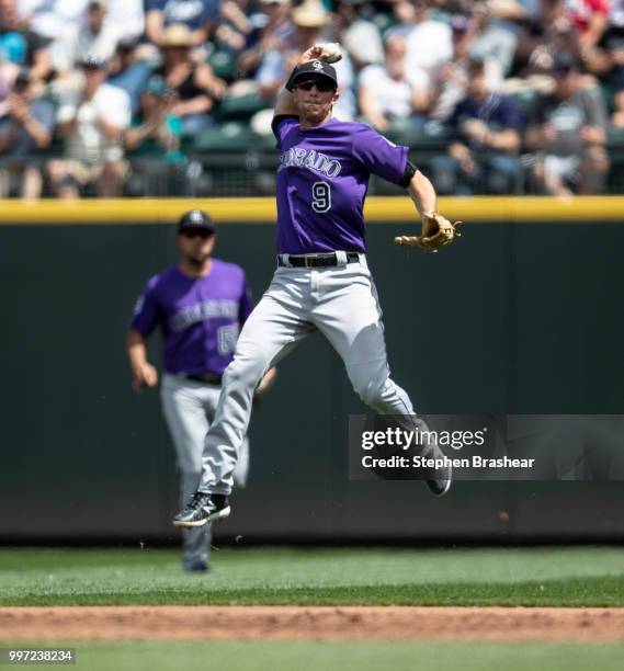 Second baseman DJ LeMahieu of the Colorado Rockies throws to first base after fielding a ground ball during a game against the Seattle Mariners at...