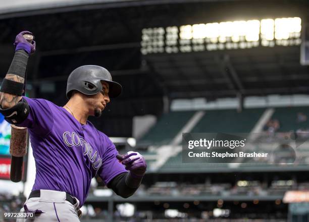 Carlos Gonzalez of the Colorado Rockies warms up in the on deck circle before an at-bat during a game against the Seattle Mariners at Safeco Field on...