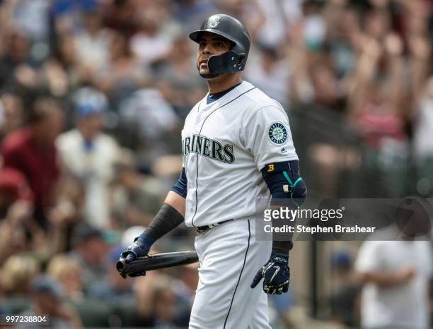 Nelson Cruz of the Seattle Mariners walks off the field after an at-bat during a game against the Colorado Rockies at Safeco Field on July 7, 2018 in...