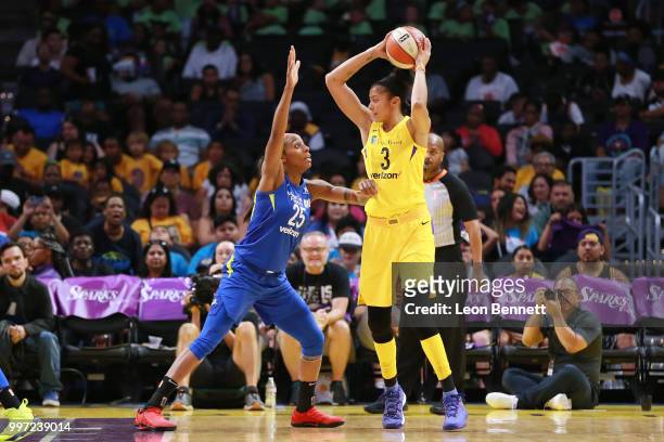 Candace Parker of the Los Angeles Sparks handles the ball against Glory Johnson of the Dallas Wings during a WNBA basketball game at Staples Center...