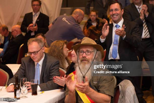 AfD supporters applaud after the first projections at an Alternative fuer Deutschland election party in Salzgitter-Lichtenberg, Germany, 15 October...