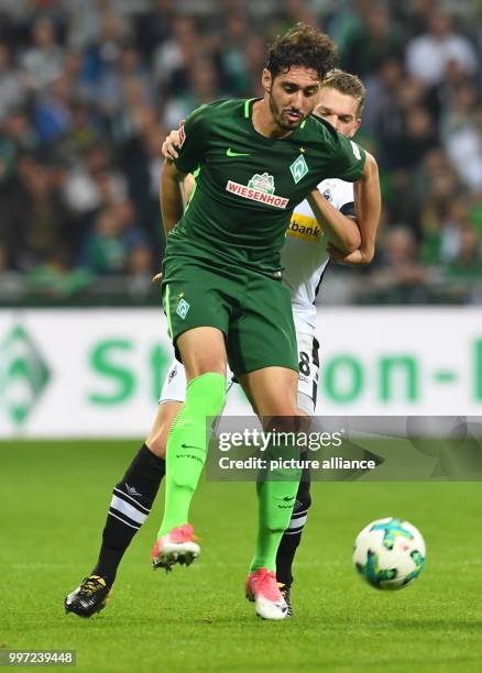 Bremen's Ishak Belfodil and Gladbach's Matthias Ginter vie for the ball during the German Bundesliga football match between Werder Bremen and...