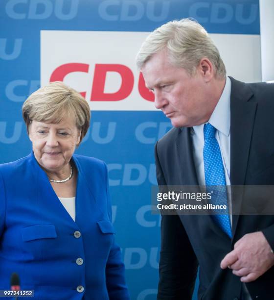 German Chancellor and leader of the Christian Democratic Union , Angela Merkel, talks to Lower Saxony CDU top candidate, Bernd Althusmann, in Berlin,...