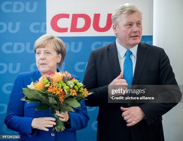 Dpatop - German Chancellor and leader of the Christian Democratic Union , Angela Merkel, poses next to Lower Saxony CDU top candidate, Bernd...