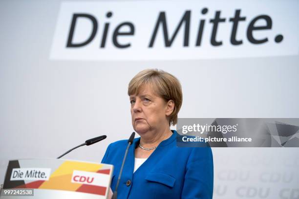 Dpatop - German Chancellor and leader of the Christian Democratic Union , Angela Merkel reacts as she speaks during a party conference in Berlin,...