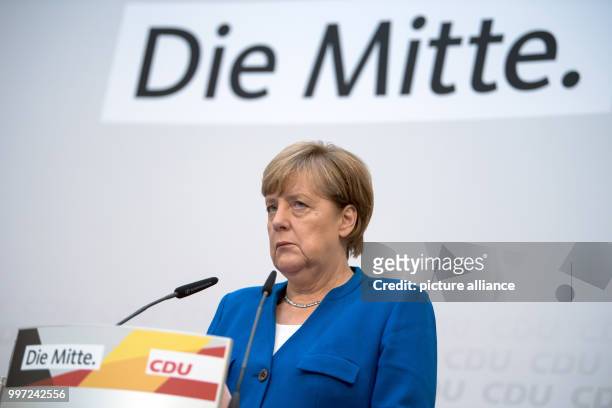German Chancellor and leader of the Christian Democratic Union , Angela Merkel reacts as she speaks during a party conference in Berlin, Germany, 16...
