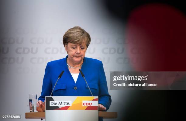 Dpatop - German Chancellor and leader of the Christian Democratic Union , Angela Merkel reacts as she speaks during a party conference in Berlin,...