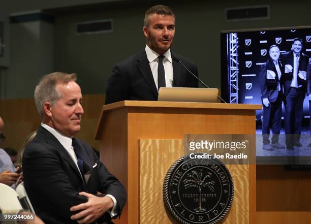 Jorge Mas listens as David Beckham speaks during a meeting at the City of Miami City Hall about building a Major League soccer stadium on a public...