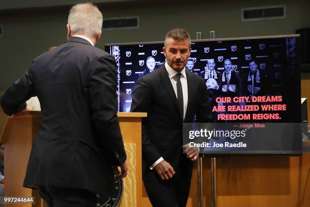 David Beckham walks to his seat after speaking during a pubic hearing at the Miami City Hall about building a Major League soccer stadium on a public...