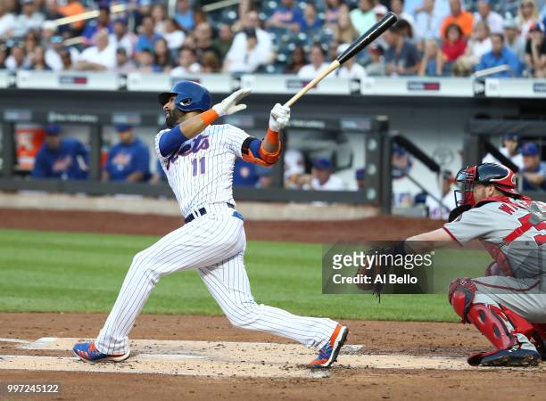 Jose Bautista of the New York Mets drives in a run in the first inning against the Washington Nationals during their game at Citi Field on July 12,...