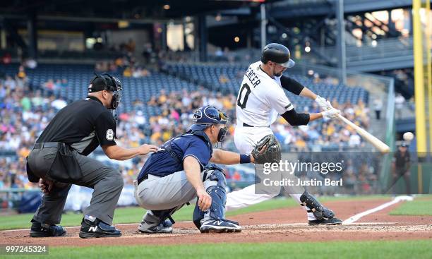 Jordy Mercer of the Pittsburgh Pirates hits an RBI single to left field in the second inning during the game against the Milwaukee Brewers at PNC...