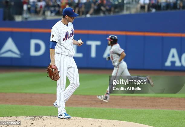 Anthony Rendon of the Washington Nationals rounds the bases after hitting a home run against Steven Matz of the New York Mets in the third inning...