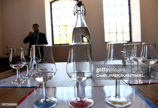 In this file photo taken on June 06, 2018 Glasses and a bottle of vodka are seen during a vodka testing event at the Polish Vodka Museum on June 6 a...