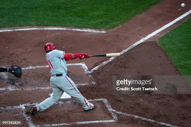 Carlos Santana of the Philadelphia Phillies hits an RBI single against the Baltimore Orioles during the third inning at Oriole Park at Camden Yards...