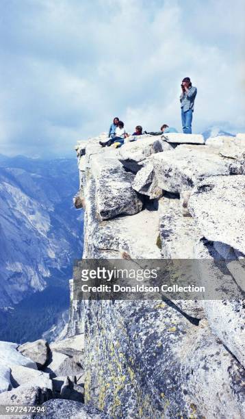 People sitting on the promontory of Half Dome on May 6, 1972 in Yosemite National Park, California. Kodak 116 w 90mm Schneider lens.