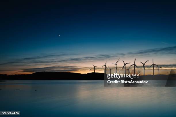 wind-turbinen bewegung landschaft sonnenuntergang - offshore windfarm stock-fotos und bilder