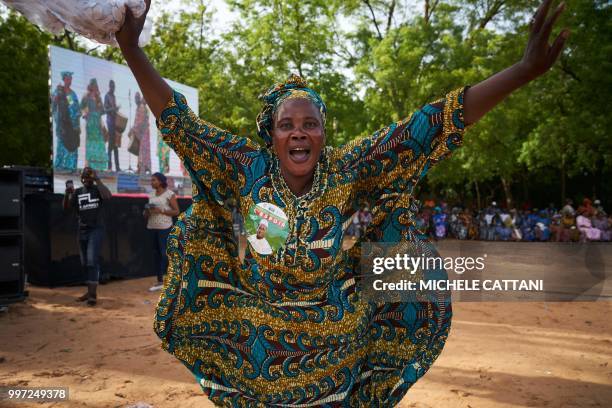Supporter of Malian opposition candidate for the presidential elections Soumaila Cisse dances before his arrival at a rally in Koulikoro on July 12,...