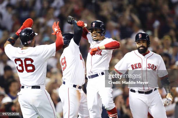 Mookie Betts of the Boston Red Sox celebrates with Eduardo Nunez, Jackie Bradley Jr. #19 and Sandy Leon after hitting a grand slam against the...