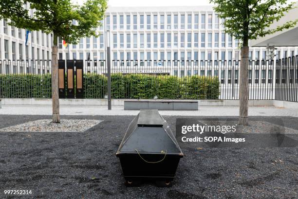 Coffin is seen laying on the ground. Activists protest in front of the Federal Ministry of Interior during the vigil for the Afghan refugee Jamal...