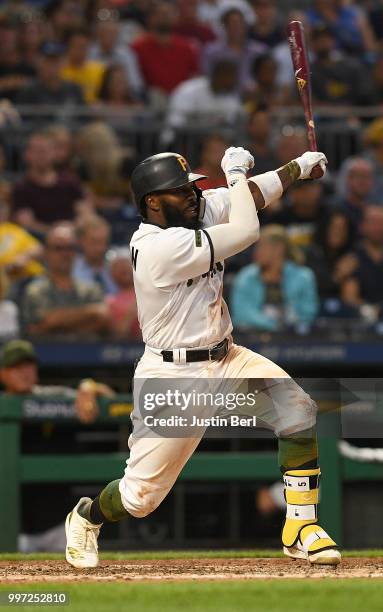 Josh Harrison of the Pittsburgh Pirates singles to center field in the sixth inning during the game against the Milwaukee Brewers at PNC Park on July...