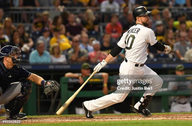 Jordy Mercer of the Pittsburgh Pirates hits a two-run single to center field in the sixth inning during the game against the Milwaukee Brewers at PNC...